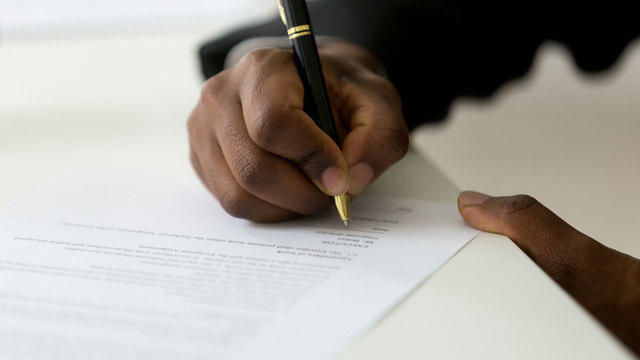 man writing letter of continued interest for law school