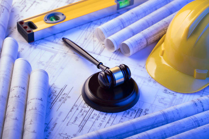 Gavel on top of construction blueprints